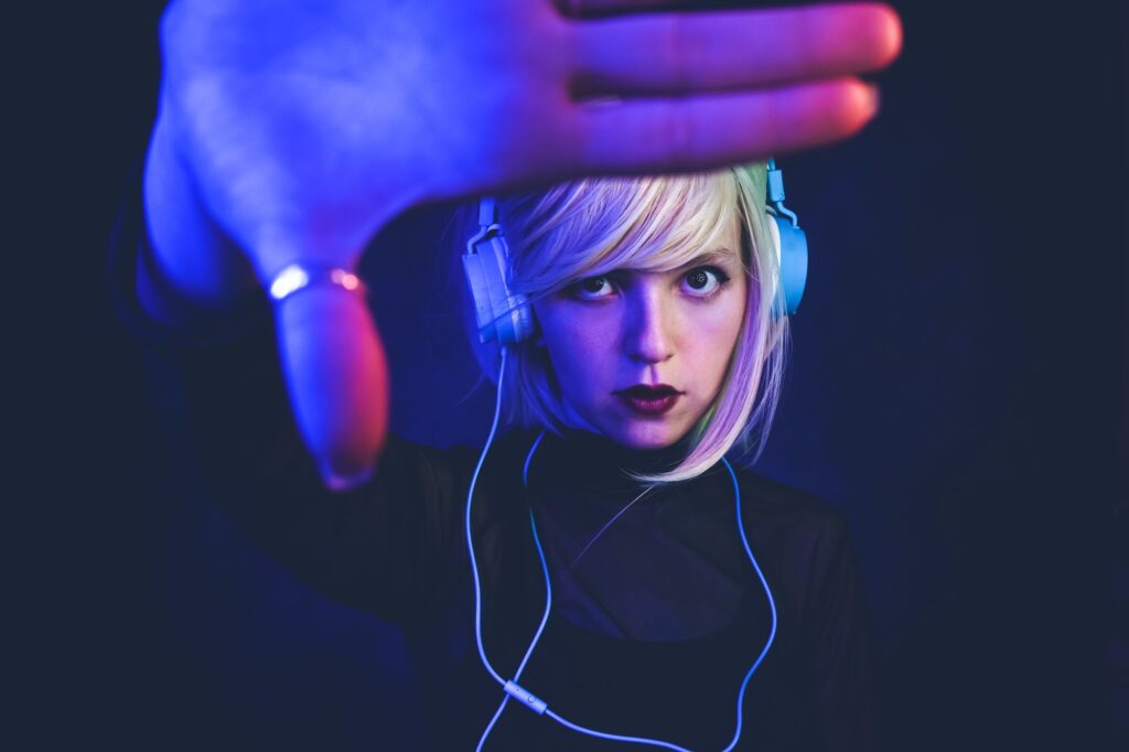 young-woman-listening-to-music-and-illuminated-by-neon-lights